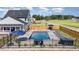 Backyard pool area with lounge seating, a hot tub, and a privacy fence, perfect for relaxation and entertaining at 1302 Reading Ct, Burlington, NC 27217