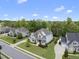 An aerial view showing the home's position on a tree-lined street, with well-maintained landscaping at 1308 Mackinaw Dr, Wake Forest, NC 27587