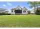 Expansive backyard featuring a screened porch and manicured lawn perfect for outdoor entertaining at 1308 Mackinaw Dr, Wake Forest, NC 27587