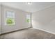 Inviting bedroom filled with light from two windows, carpeted and neutral color scheme at 1308 Mackinaw Dr, Wake Forest, NC 27587