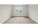 Bright, carpeted bedroom featuring large windows and neutral walls at 1308 Mackinaw Dr, Wake Forest, NC 27587