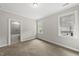 Bright, neutral bedroom with carpet, two windows and an ensuite bathroom at 1308 Mackinaw Dr, Wake Forest, NC 27587