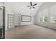 Finished bonus room with projector screen, built-in shelving and natural light at 1308 Mackinaw Dr, Wake Forest, NC 27587