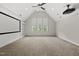 Finished bonus room featuring built-in shelving, projector and screen with natural light at 1308 Mackinaw Dr, Wake Forest, NC 27587
