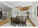Formal dining room with hardwood floors, modern lighting, and views into living room and outdoor patio at 1308 Mackinaw Dr, Wake Forest, NC 27587
