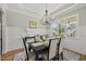 A large dining room featuring decorative wainscoting, a black dining table, and large windows at 1308 Mackinaw Dr, Wake Forest, NC 27587