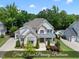 An exterior shot of the two-story home boasting manicured lawn, brickwork, and neutral paint at 1308 Mackinaw Dr, Wake Forest, NC 27587