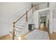 A luxurious two story foyer features a staircase with white banister and wooden handrail, plus paneled walls at 1308 Mackinaw Dr, Wake Forest, NC 27587