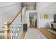 Luxurious two story foyer and paneled walls with a stair case featuring a white banister and wooden handrail at 1308 Mackinaw Dr, Wake Forest, NC 27587