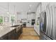 Modern kitchen with stainless steel appliances, white cabinets, and a large center island at 1308 Mackinaw Dr, Wake Forest, NC 27587