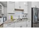 Kitchen features white cabinetry, granite countertops, stainless steel appliances, and subway tile backsplash at 1308 Mackinaw Dr, Wake Forest, NC 27587
