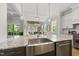 Open kitchen features granite countertops, stainless steel appliances, and views into the dining area at 1308 Mackinaw Dr, Wake Forest, NC 27587