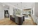 Open concept kitchen with stainless appliances, granite island, and hardwood floors open to dining room at 1308 Mackinaw Dr, Wake Forest, NC 27587