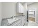 Convenient laundry room equipped with ample cabinet space, a utility sink, and access to a closet at 1308 Mackinaw Dr, Wake Forest, NC 27587