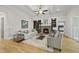 An expansive living room featuring a stone fireplace, built-in shelving, and coffered ceiling at 1308 Mackinaw Dr, Wake Forest, NC 27587