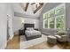 Vaulted main bedroom featuring paneled accent wall and large windows with lush backyard view at 1308 Mackinaw Dr, Wake Forest, NC 27587