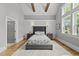 Spacious main bedroom featuring vaulted ceiling, paneled accent wall, and hardwood floors at 1308 Mackinaw Dr, Wake Forest, NC 27587