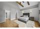 Large main bedroom with a paneled accent wall, hardwood floors and ensuite bath at 1308 Mackinaw Dr, Wake Forest, NC 27587