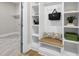 Well-organized mudroom with custom shelving, hooks, and a bench at 1308 Mackinaw Dr, Wake Forest, NC 27587
