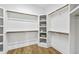 Walk-in closet with multiple shelves and hanging rods for maximum storage at 1308 Mackinaw Dr, Wake Forest, NC 27587