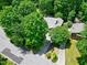 Aerial view of the property, showcasing lush trees and the home's setting and neighborhood at 1416 Dunbar Ct, Cary, NC 27511
