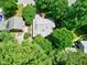 A home surrounded by mature trees, shot from above on a bright, sunny day at 1416 Dunbar Ct, Cary, NC 27511