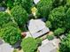 An aerial view of a house with a gray roof surrounded by large, green trees at 1416 Dunbar Ct, Cary, NC 27511