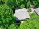 Aerial image of a home with a gray roof, surrounded by lush, mature trees at 1416 Dunbar Ct, Cary, NC 27511