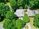 An aerial view of a home surrounded by mature trees showcasing the property's privacy at 1416 Dunbar Ct, Cary, NC 27511