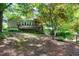 Exterior view of home's deck and lush backyard with mature trees at 1416 Dunbar Ct, Cary, NC 27511