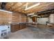 Unfinished basement features work area, wooden shelving, and overhead lighting at 1416 Dunbar Ct, Cary, NC 27511