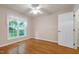 Bedroom features hardwood floors, a ceiling fan, and a window with lace curtains at 1416 Dunbar Ct, Cary, NC 27511