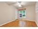 This bedroom features hardwood floors, a ceiling fan, and a window at 1416 Dunbar Ct, Cary, NC 27511
