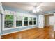 Bright bedroom with hardwood floors, ceiling fan, and large windows with views at 1416 Dunbar Ct, Cary, NC 27511