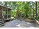 A view of the wood deck and stairs with lush greenery, perfect for relaxing and enjoying the outdoors at 1416 Dunbar Ct, Cary, NC 27511
