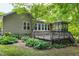 Exterior of home features a deck and lush landscaping at 1416 Dunbar Ct, Cary, NC 27511