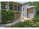 Exterior of the home with a screened porch, stone pathway, and access to the garage at 1416 Dunbar Ct, Cary, NC 27511