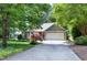 Ranch home featuring an attached garage and a well-maintained front yard with mature trees at 1416 Dunbar Ct, Cary, NC 27511