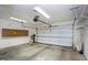 Spacious garage with overhead lighting, ample storage cabinets, and automatic door opener at 1416 Dunbar Ct, Cary, NC 27511