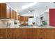 A bright kitchen featuring wood cabinets, granite countertops, and modern appliances at 1416 Dunbar Ct, Cary, NC 27511