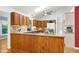 A spacious kitchen with wood cabinets, granite countertops, and stainless-steel appliances at 1416 Dunbar Ct, Cary, NC 27511