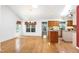 Spacious living room with wood floors, skylight, and adjacent kitchen area at 1416 Dunbar Ct, Cary, NC 27511