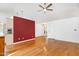 Bright living room featuring hardwood floors, vaulted ceiling, and a ceiling fan at 1416 Dunbar Ct, Cary, NC 27511