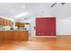 Large open-concept room with wood floors, skylights, and views of the kitchen area at 1416 Dunbar Ct, Cary, NC 27511