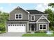 Charming two-story home with gray siding, white trim, a two-car garage, and well-manicured lawn at 15 Malbec Way, Youngsville, NC 27596