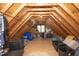 Spacious attic for storage, with wood beams and a small window at 1605 Heritage Club Ave, Wake Forest, NC 27587