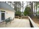 Wooden back deck with green metal table and chairs overlooking the backyard at 1605 Heritage Club Ave, Wake Forest, NC 27587