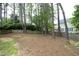Fenced backyard with mature trees offering shade and privacy to the property at 1605 Heritage Club Ave, Wake Forest, NC 27587