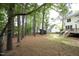 Backyard with mature trees offering shade and privacy to the property at 1605 Heritage Club Ave, Wake Forest, NC 27587