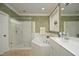 Bright bathroom featuring a glass-enclosed shower, soaker tub and vanity with white cabinets at 1605 Heritage Club Ave, Wake Forest, NC 27587